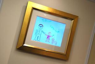 frame drawing picture of Dr. Lam and children