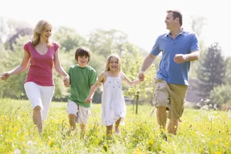 happy family running in a field