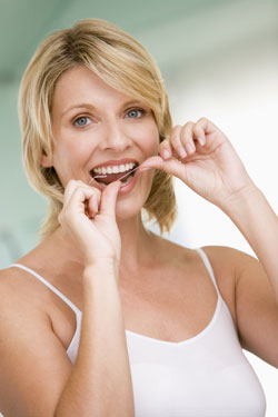 lady flossing teeth