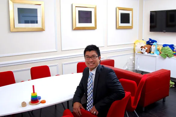 Dr. Lam smiling in a conference room